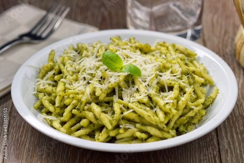 Obraz na plátně Pasta with pesto sauce and parmesan on a plate.