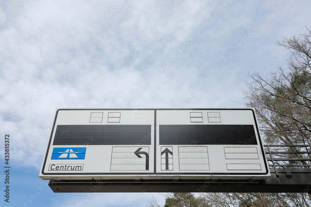 sign for street information, arrows and traffic board with sky and clouds sign for street information, arrows and traffic board with sky and clouds