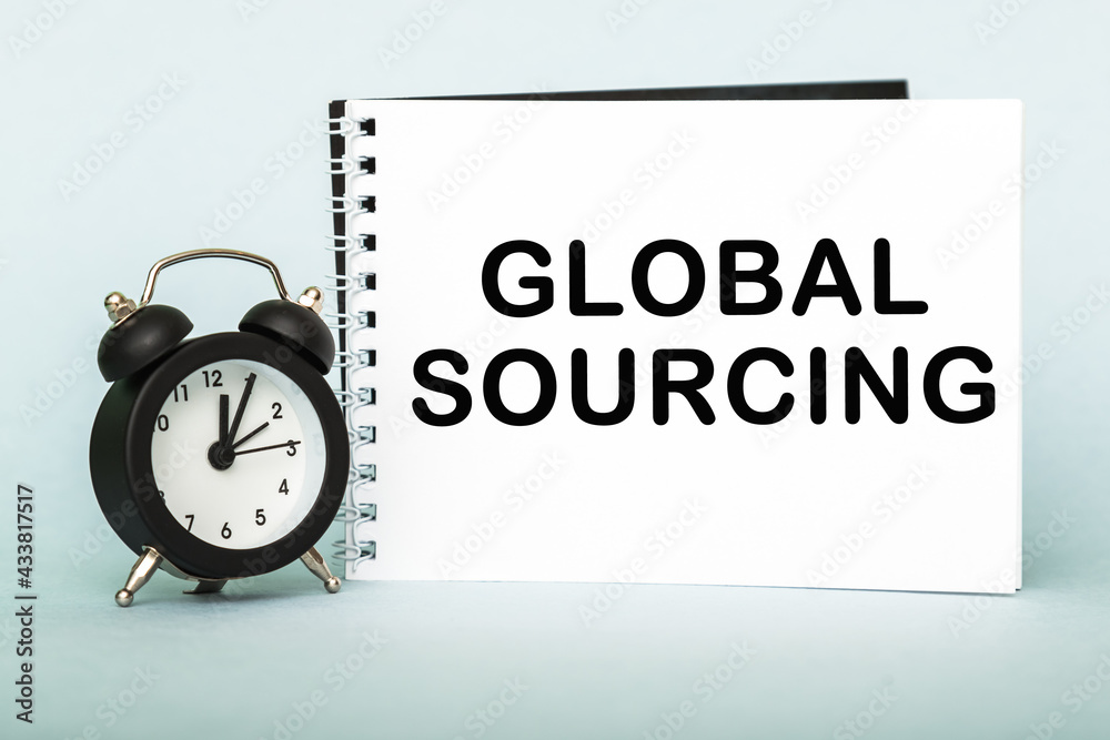 A words GLOBAL SOURCING on notebook with clock. Concept for time management and business. A words GLOBAL SOURCING on notebook with clock. Concept for time management and business.