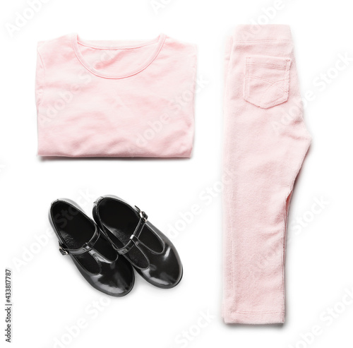 Set of child's clothes on white background