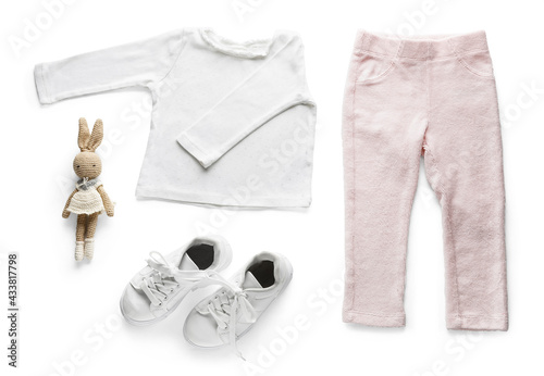 Set of child's clothes on white background
