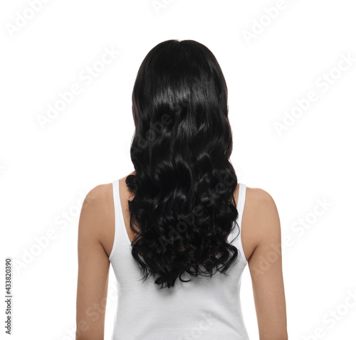Young woman with long curly hair on white background, back view