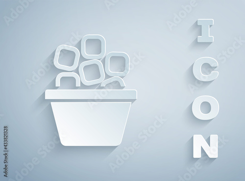 Paper cut Ice bucket filled with ice cubes icon isolated on grey background. Paper art style. Vector