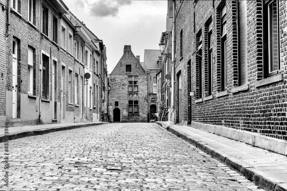 black and white low angle view of typical brick buildings in the historic city center of Bruges
