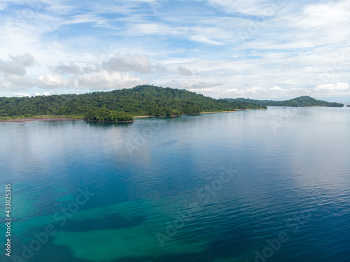 Beautiful shot of the sea under a blue cloudy sky in Indonesia photo