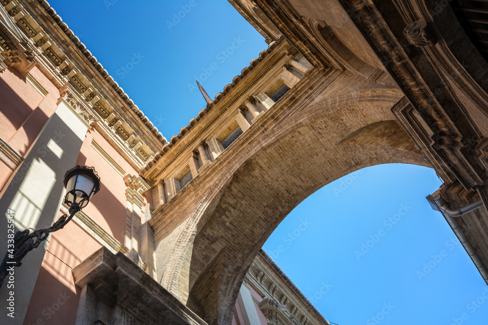 Perspective view of an ancient arch between Cathedral and Basilica Desamparados, Valencia, Spain