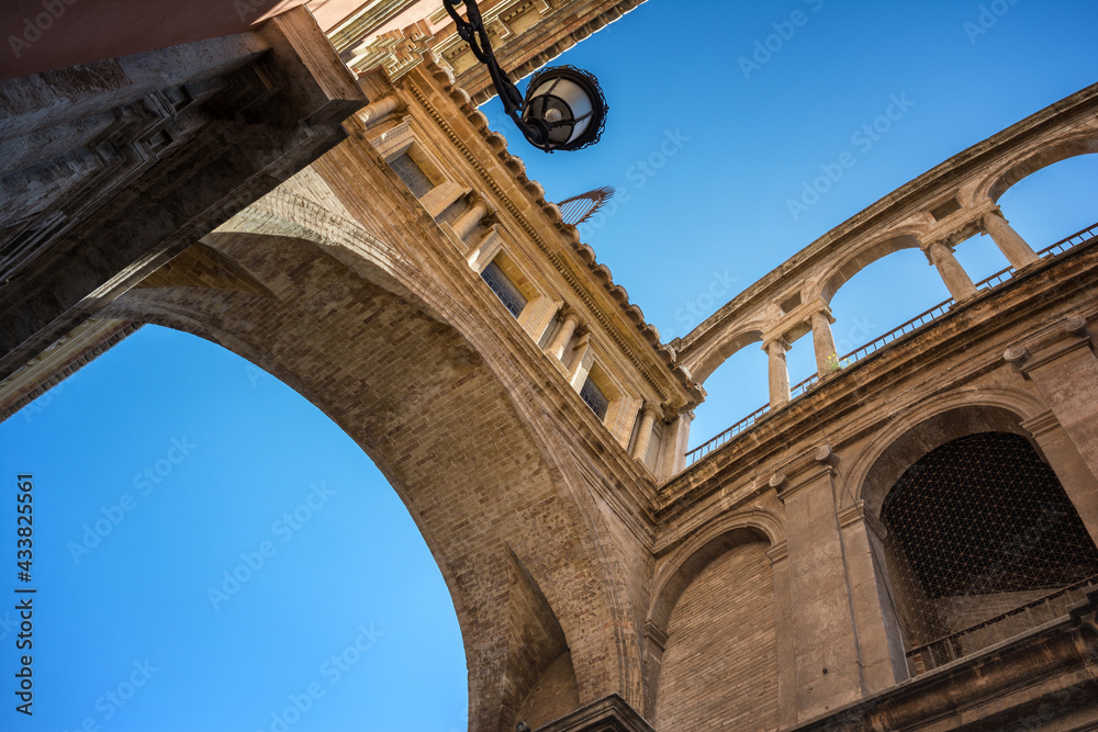 Perspective view of an ancient arch between Cathedral and Basilica Desamparados, Valencia, Spain