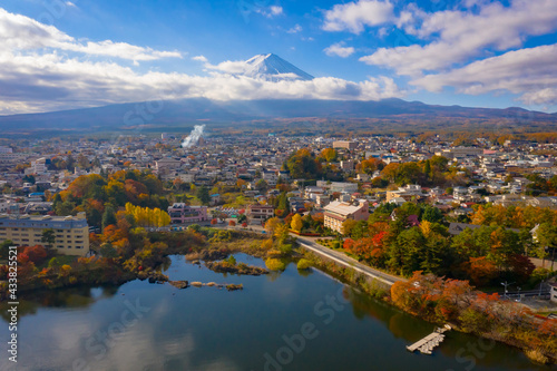 Fujikawaguchiko city in Japan. Fujiyama volcano view. Panorama with Lake Kawaguchikom. Mount Fuji on a summer day. Fuji volcano towers over city. Travel to Japan. Autumn landscape with Mount Fujiyama photo