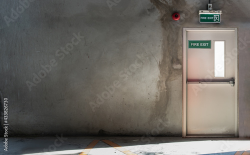 Fire exit door for emergency case with alarm for safety protection of the car parking building. Safety first concept, Copy space, Selective focus.