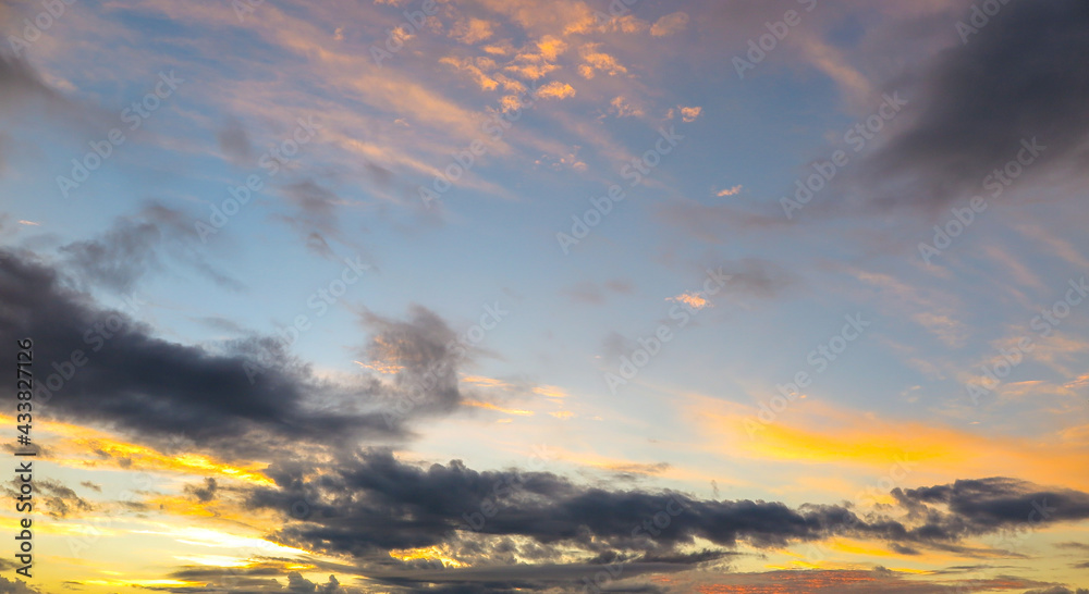 Multicolored and black clouds on a blue background sky