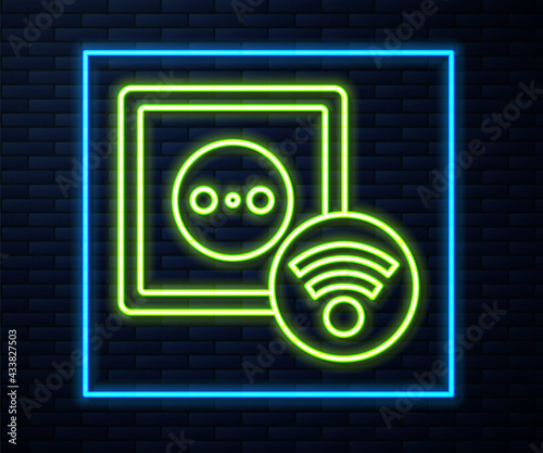 Glowing neon line Smart electrical outlet system icon isolated on brick wall background. Power socket. Internet of things concept with wireless connection. Vector