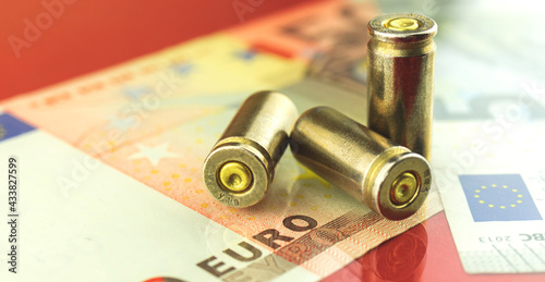 Bullet and euro money, banknotes, finance and security background photo