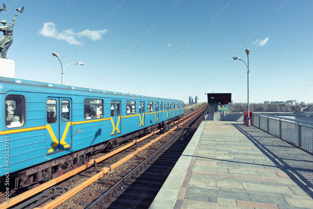 Naklejka premium The Kiev metro train rides across the bridge over the Dnieper River