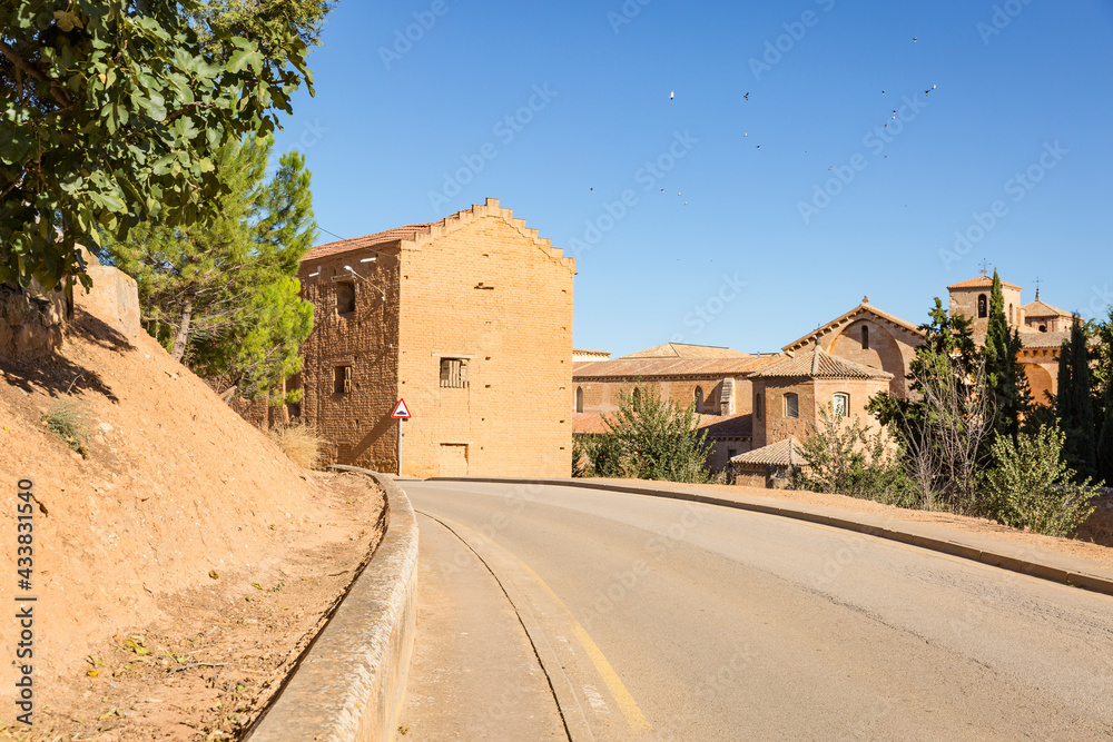 a paved road passing through Santa Maria de Huerta village, province of Soria, Castile and Leon, Spain