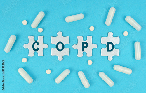 On a blue background, there are pills and puzzles with the inscription - COPD