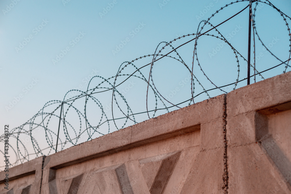 Concrete fence with barbed wire. Secret object. Concrete fence with barbed wire. Secret object.