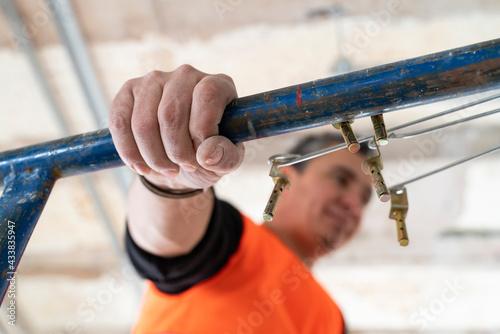 Man working with on scaffolding in construction site