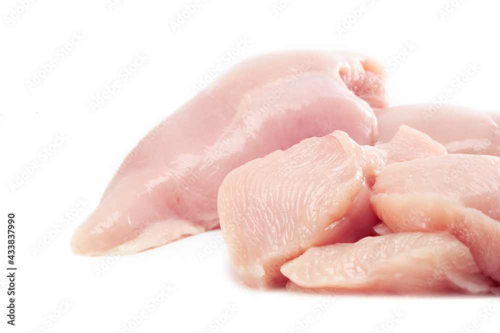 Fresh raw chicken breast fillet whole and sliced isolated closeup on white background, clipping path Fresh raw chicken breast fillet whole and sliced isolated closeup on white background, clipping path