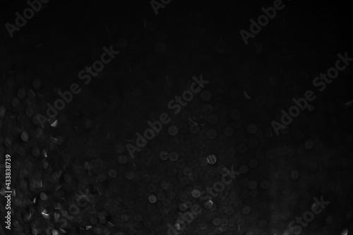 Rain On black background Glass. Background with bokeh. Black and white foto. High quality photo