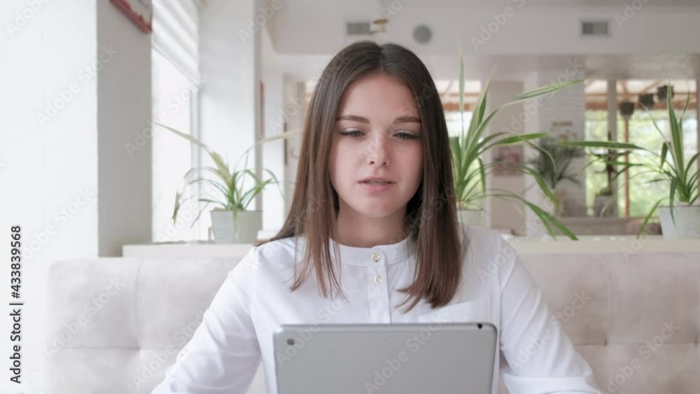 Young beautiful girl has fun talking to the other person in front of Young beautiful girl has fun talking to the other person in front of