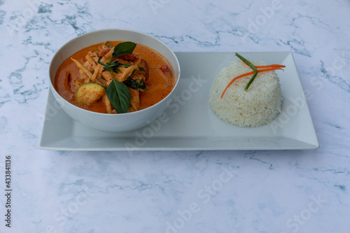 Kang Ped, Assorted Thai food, Thai Food Mixed Dishes, Red curry stew with coconut milk, bamboo shoots, carrot, paprika, and Thai basil. Served with rice. photo