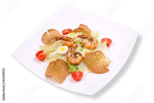 Caesar salad with shrimps. white background, white plate.