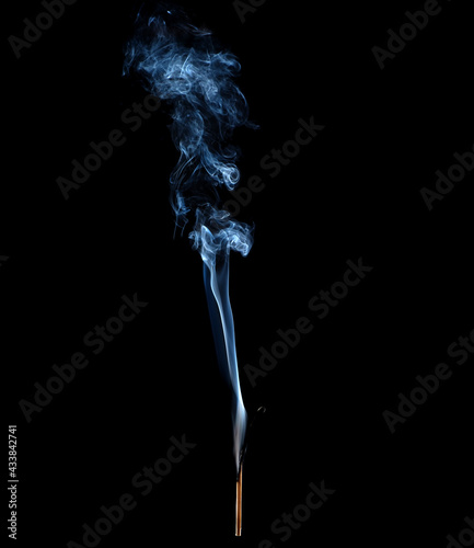 Smoky and burnt matchstick isolated on black background