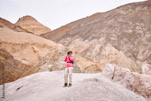 A family with a teenage girl is hiking Dante’s View trail in Death Valley National Park in California, USA during their road trip from Las Vegas to San Francisco in March 2021 during COVID-19 pandemic