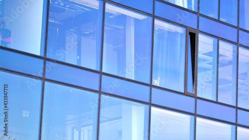 Mirrored windows of the facade of an office building. Abstract texture of blue glass modern office building. Business background.