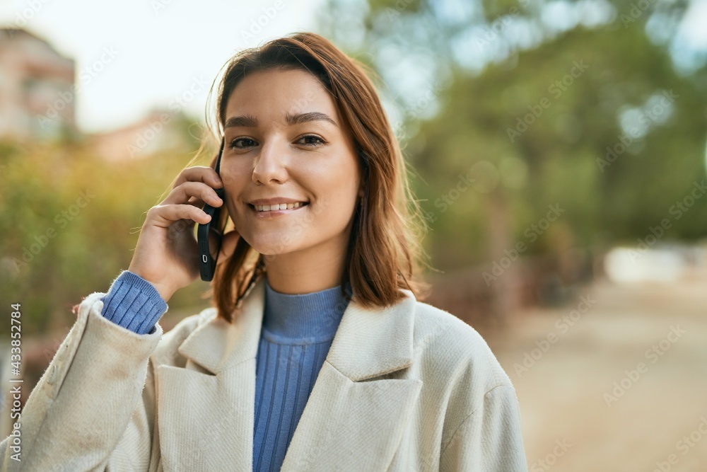 Young hispanic woman smiling happy talking on the smartphone at the park. Young hispanic woman smiling happy talking on the smartphone at the park.