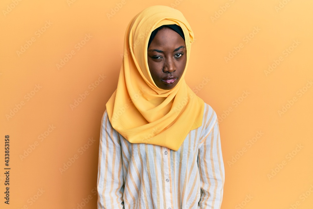 Beautiful african young woman wearing traditional islamic hijab scarf skeptic and nervous, frowning upset because of problem. negative person. Beautiful african young woman wearing traditional islamic hijab scarf skeptic and nervous, frowning upset because of problem. negative person.