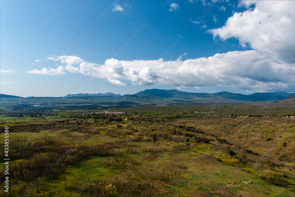 Obraz premium Rural landscape with spectacular mountains in the background. Horizontal aerial photography with drone. Concept of life, vacation, fun and adventure. Selective focus