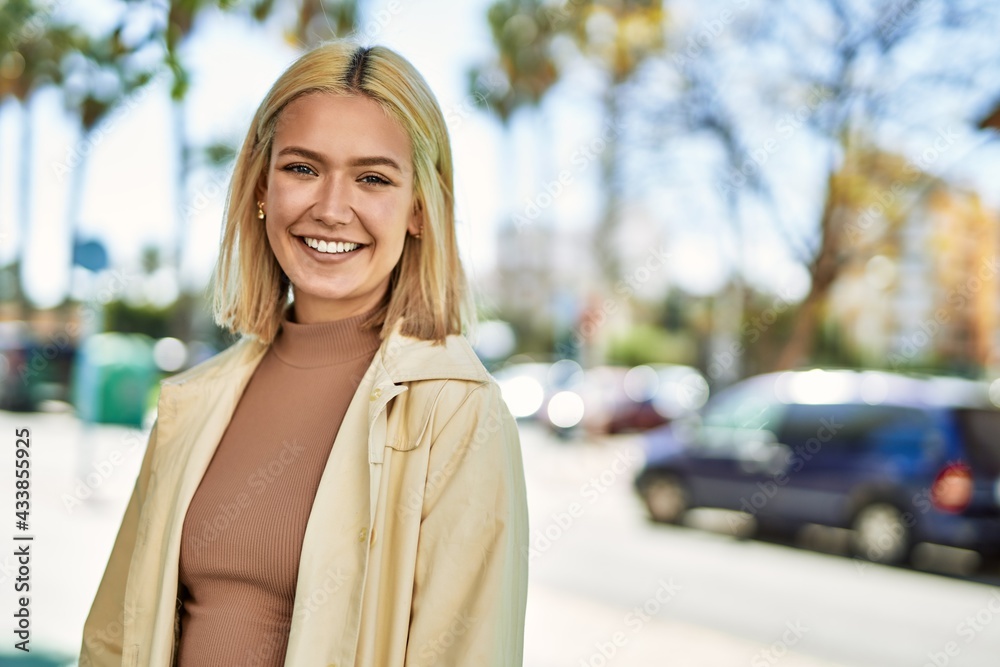 Young blonde girl smiling happy standing at the city. Young blonde girl smiling happy standing at the city.