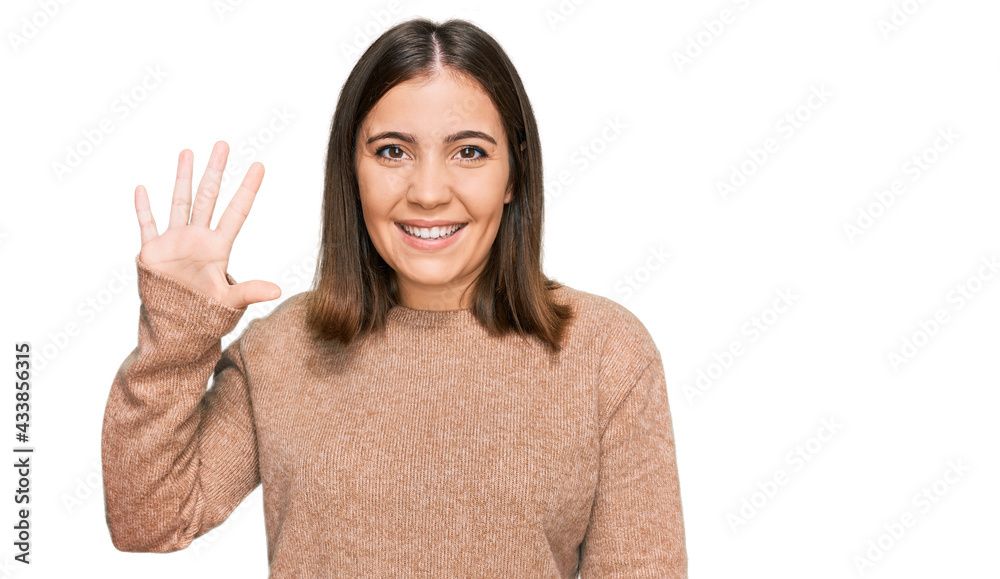 Young beautiful woman wearing casual clothes showing and pointing up with fingers number five while smiling confident and happy. Young beautiful woman wearing casual clothes showing and pointing up with fingers number five while smiling confident and happy.
