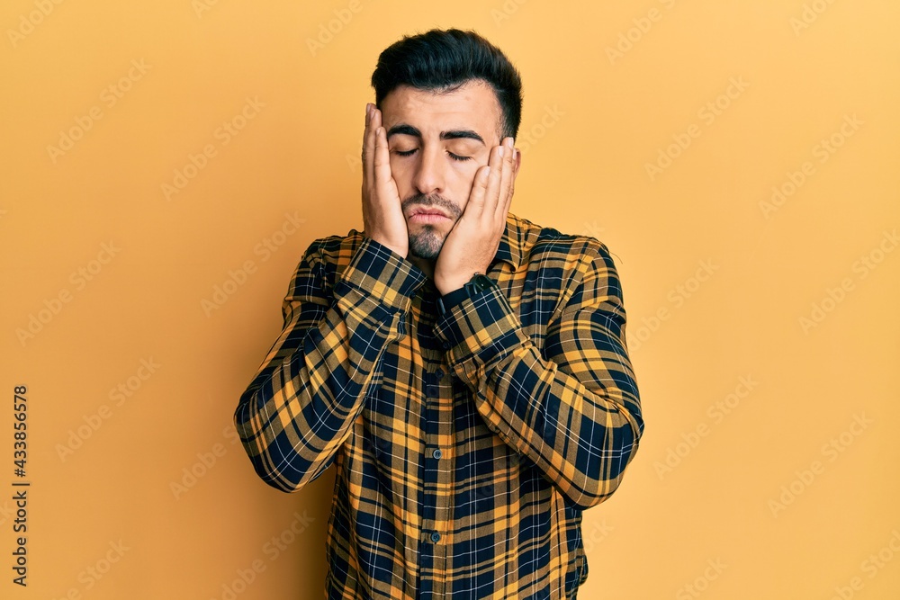 Young hispanic man wearing casual clothes tired hands covering face, depression and sadness, upset and irritated for problem Young hispanic man wearing casual clothes tired hands covering face, depression and sadness, upset and irritated for problem