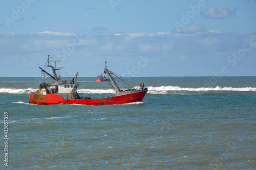 Red fishing boat on the sea