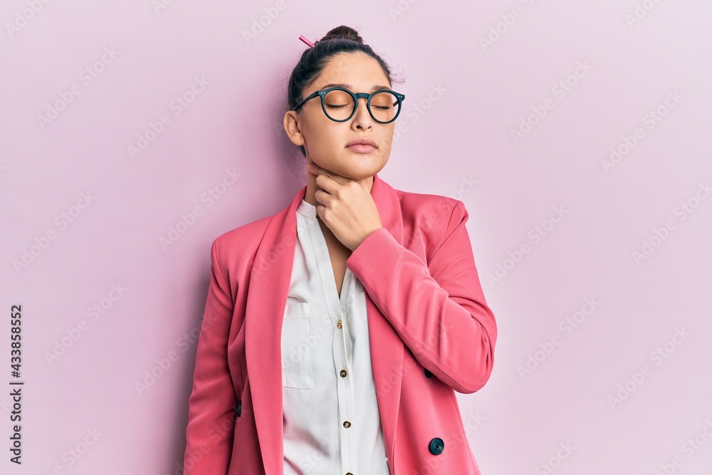 Beautiful middle eastern woman wearing business jacket and glasses touching painful neck, sore throat for flu, clod and infection