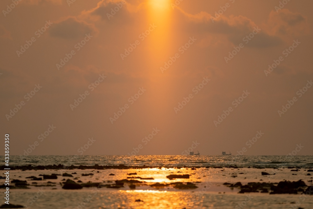 Fototapeta premium Amazing light of Sunset or sunrise over sea landscape nature with rocks in the foreground
