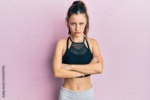 Young brunette woman wearing sportswear skeptic and nervous, disapproving expression on face with crossed arms. negative person. © Krakenimages.com