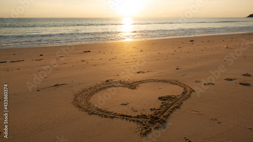 Heart symbol on beach  Hand drawn heart on beach sand over sunset or sunrise sky beautiful light nature landscape