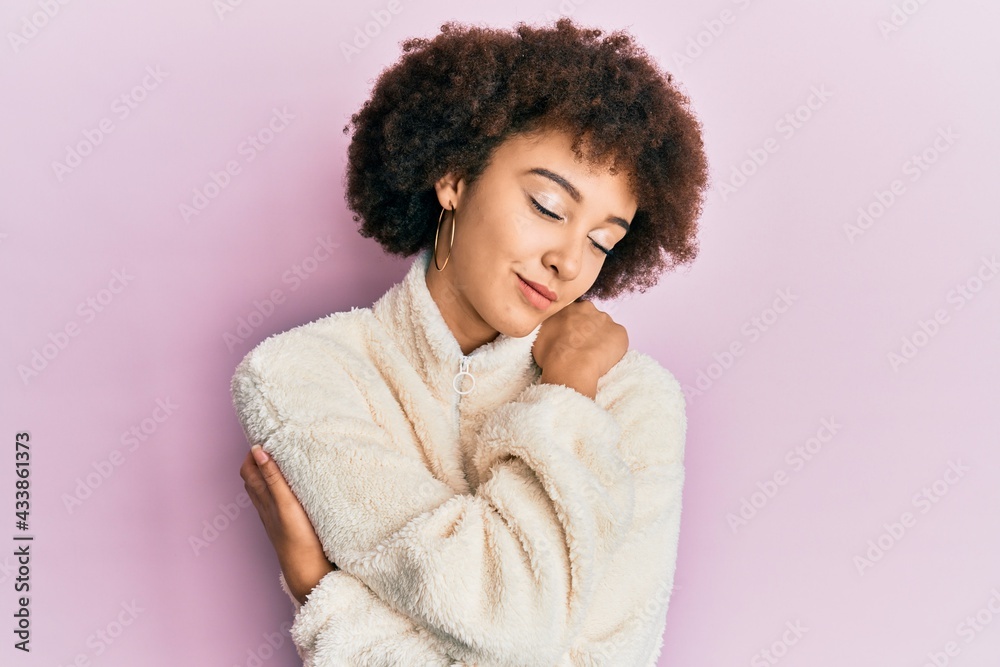 Young hispanic girl wearing casual clothes hugging oneself happy and positive, smiling confident. self love and self care
