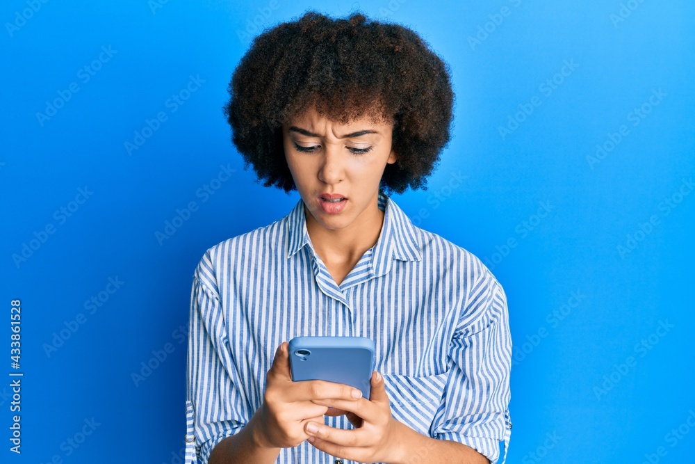 Young hispanic girl using smartphone clueless and confused expression. doubt concept. Young hispanic girl using smartphone clueless and confused expression. doubt concept.