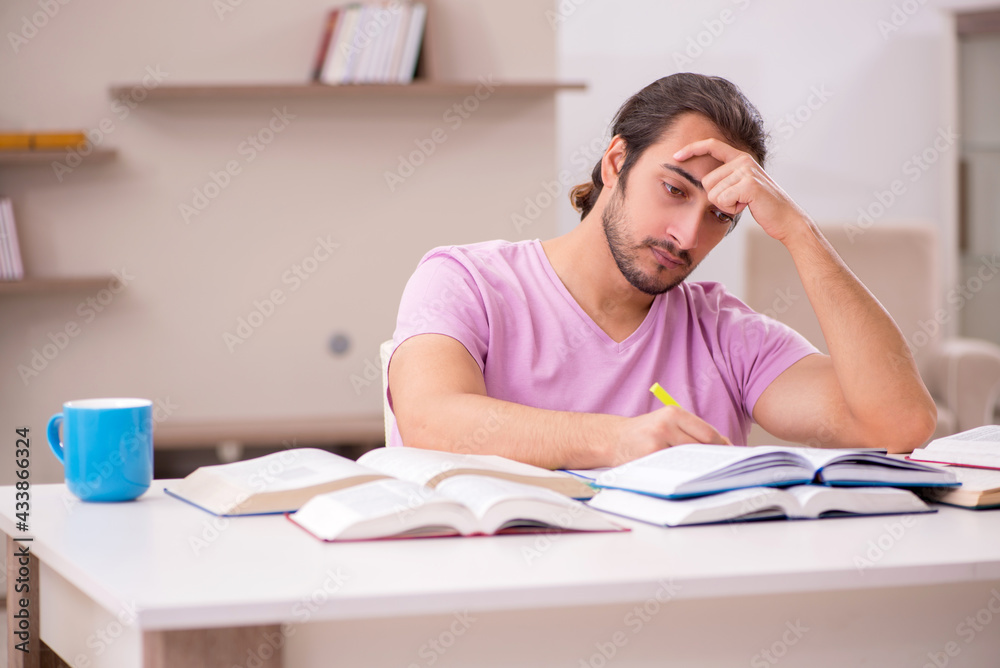 Young male student preparing for exams at home Young male student preparing for exams at home