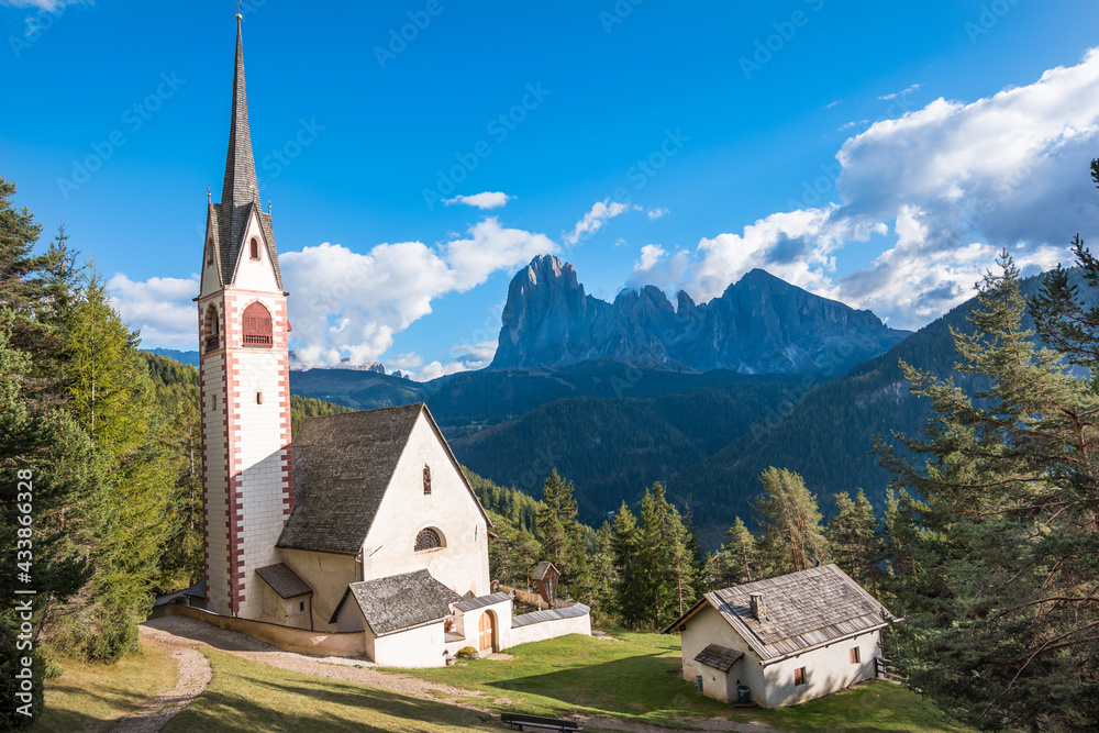Beautiful view of the Church of St. Johann in Ranui and Dolomites in the background - Val di Funes BZ, Italy