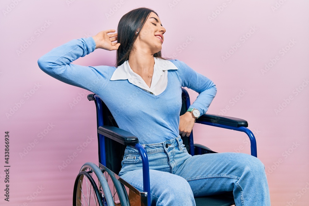 Beautiful woman with blue eyes sitting on wheelchair stretching back, tired and relaxed, sleepy and yawning for early morning Beautiful woman with blue eyes sitting on wheelchair stretching back, tired and relaxed, sleepy and yawning for early morning