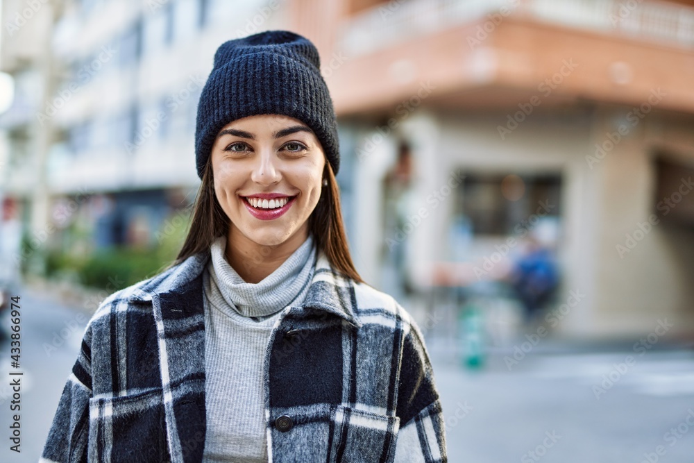 Young hispanic woman smiling happy standing at the city. Young hispanic woman smiling happy standing at the city.