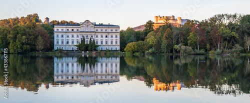 Beautiful sunset colors in Leopoldskroner Weiher Lake with Leopoldskron Palace and Hohensalzburg Fortress in the background - Salzburg, Austria 