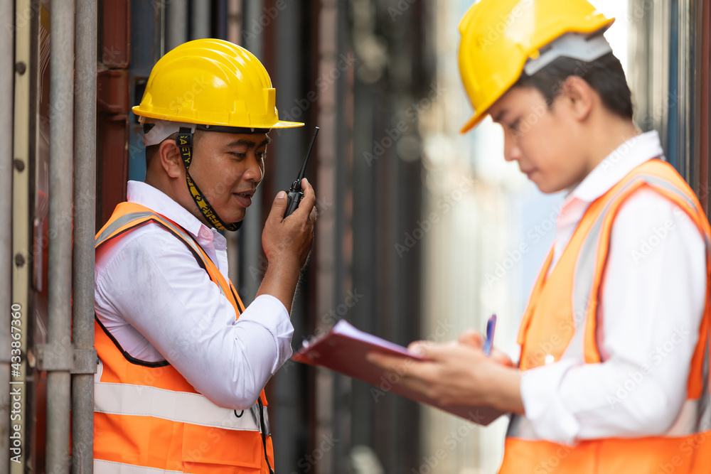 factory worker or engineer using walkie talkie for preparing a job in containers warehouse storage factory worker or engineer using walkie talkie for preparing a job in containers warehouse storage