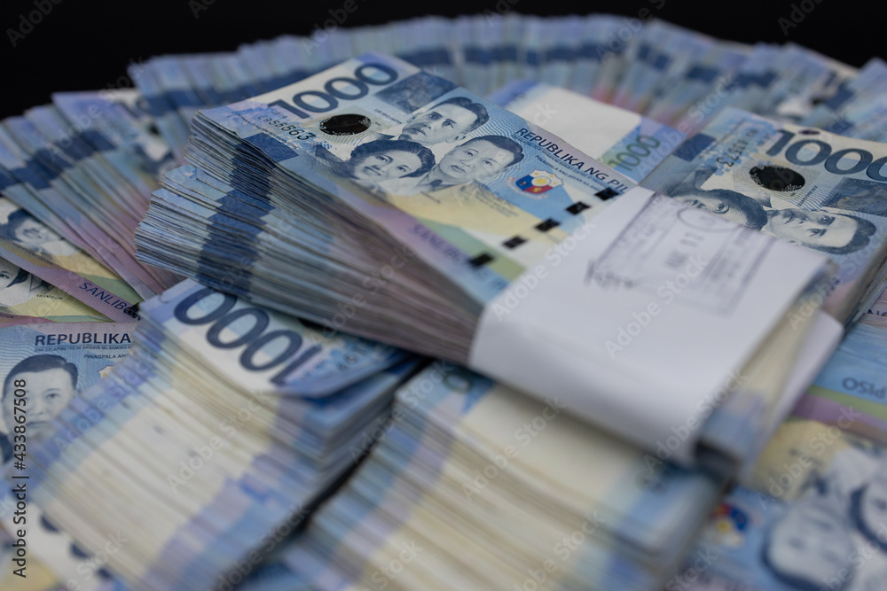 A pile of one thousand Philippines peso banknotes. Cash of Thousand dollar bills, Peso background image.