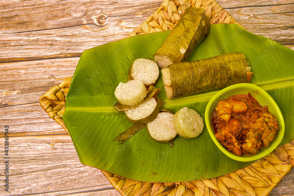 Malay traditional food called as Lemang and chicken rendang served ...